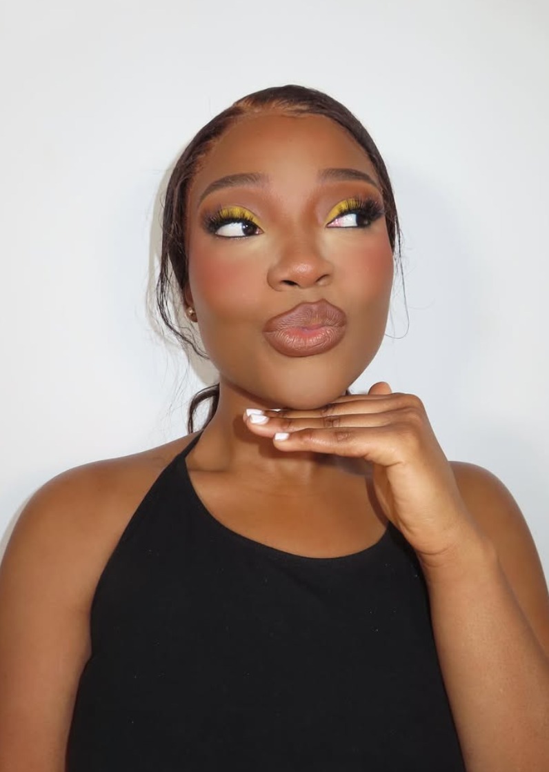Bold yellow eyeshadow glam look with warm blush by Hillary Ababio MUA
